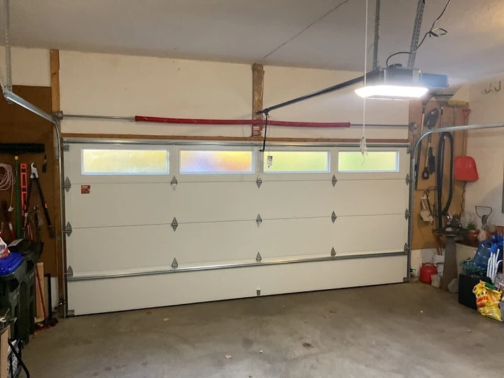 A white residential garage door with windows.