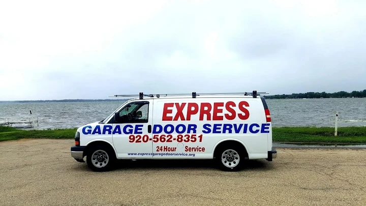 Express Garage Door Service van parked by a lake.