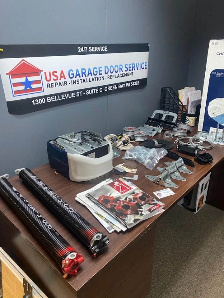Garage door repair parts and equipment on a desk.