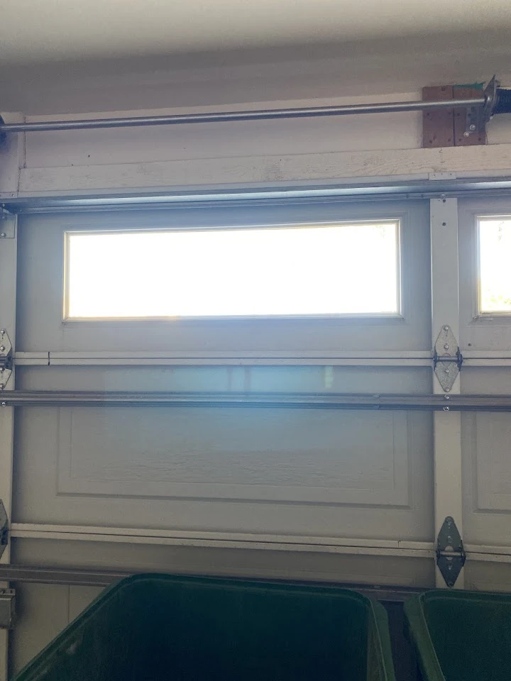 Garage door window panel and spring assembly.