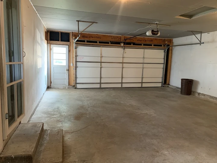 Interior of a clean, empty two-car garage.