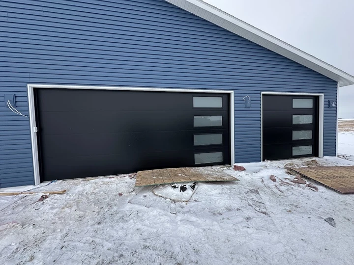 Modern black garage doors by Alpine Garage Doors.
