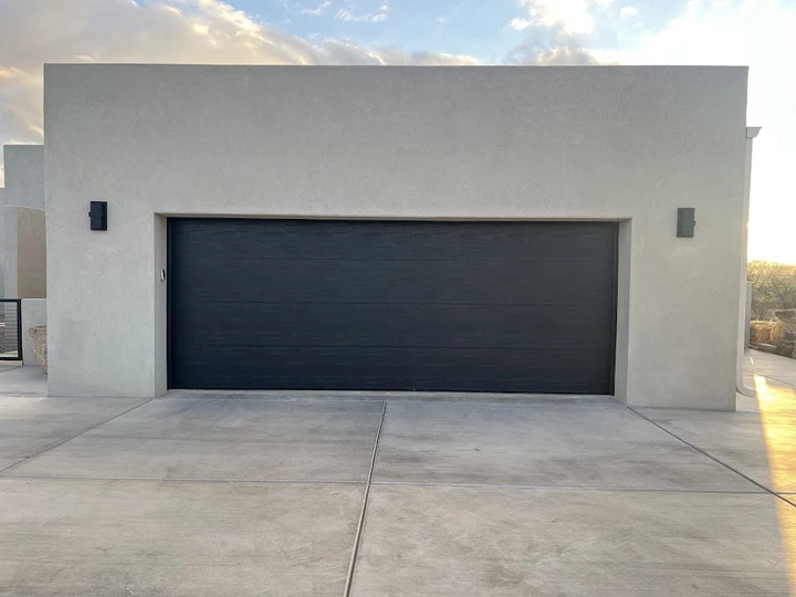 Modern dark garage door by C & D Garage Doors.
