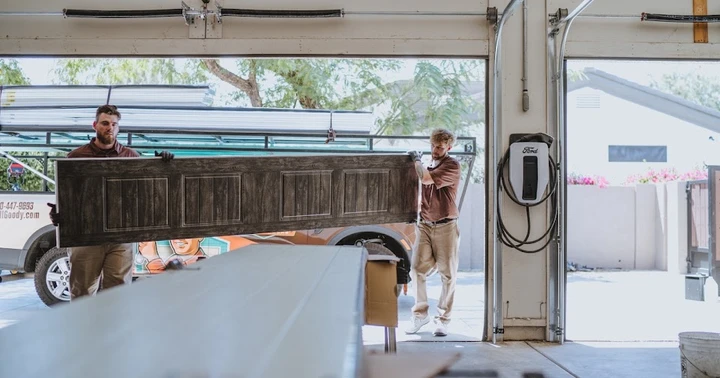 Technicians installing a garage door.