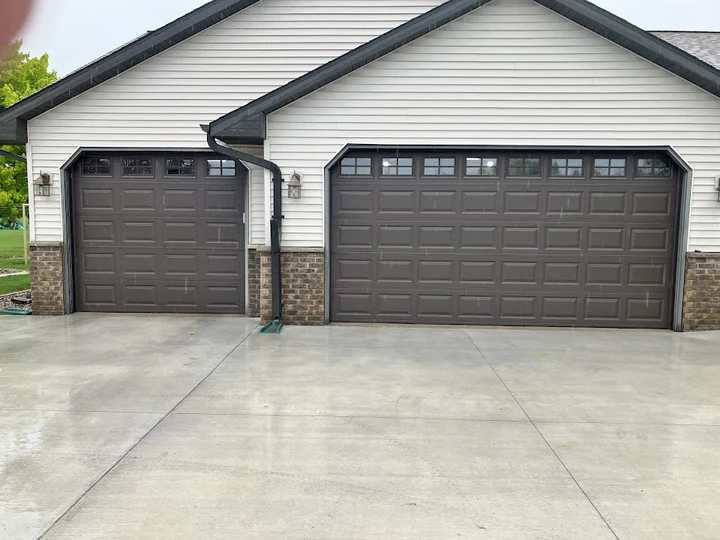 Two dark brown residential garage doors.