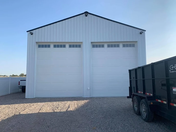 Two new white residential garage doors.