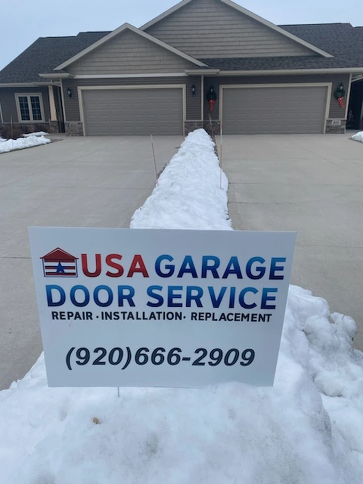 USA Garage Door Service sign in front of a house.