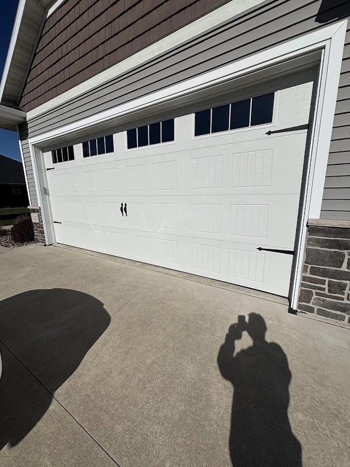 White residential garage door with decorative windows.