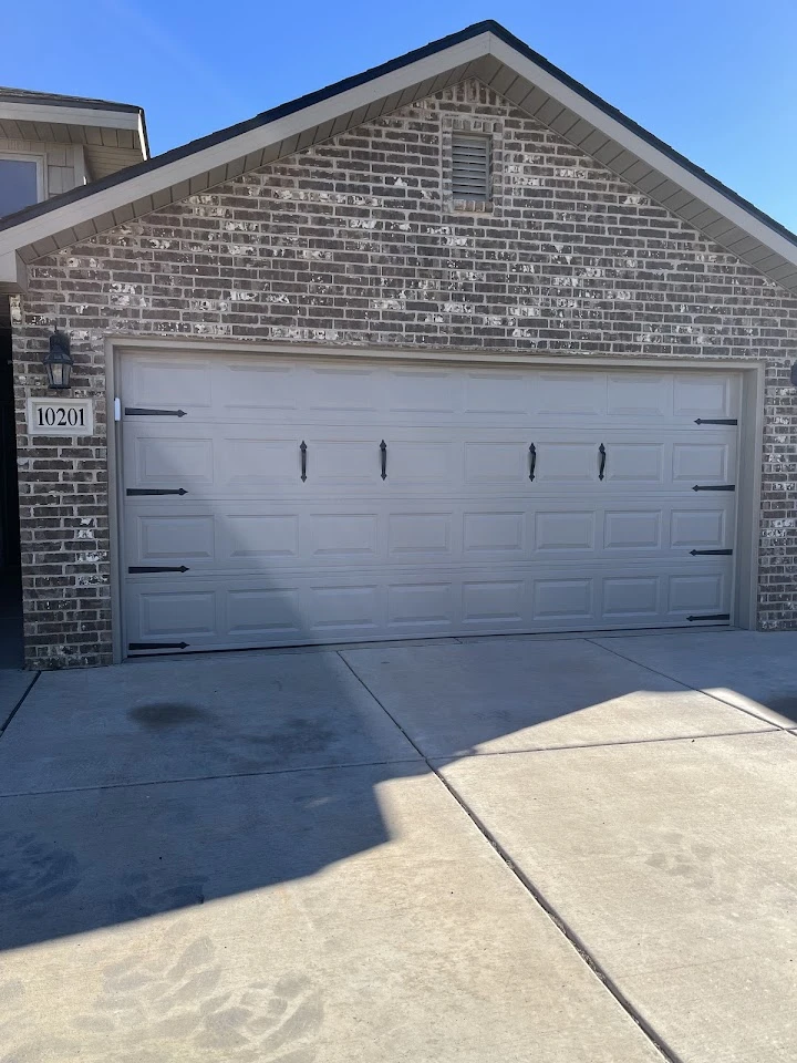 A standard garage door for a brick home.