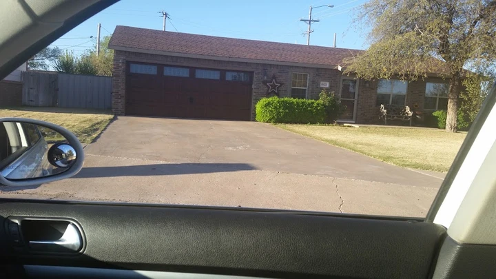 A traditional home with a brown sectional garage door.