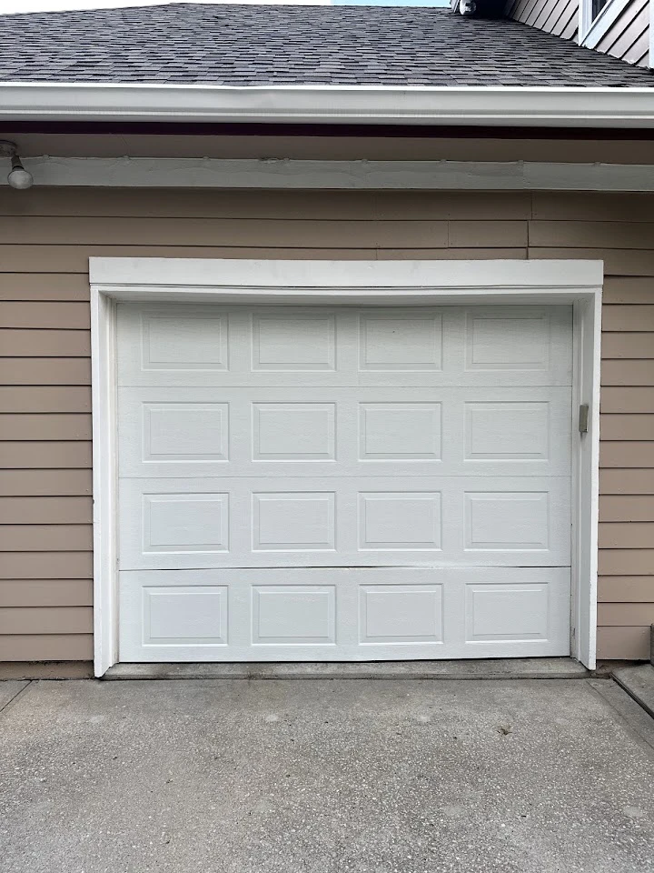 A white, four-panel residential garage door.