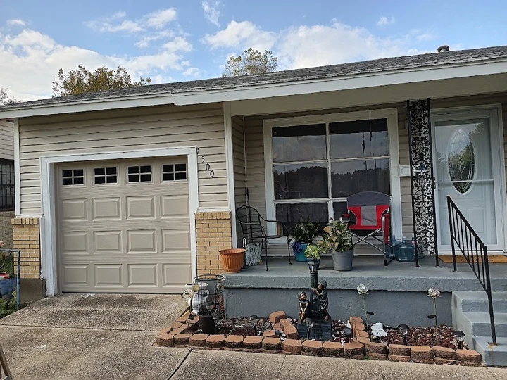 Abel's Garage Doors: Tan home with sectional door.