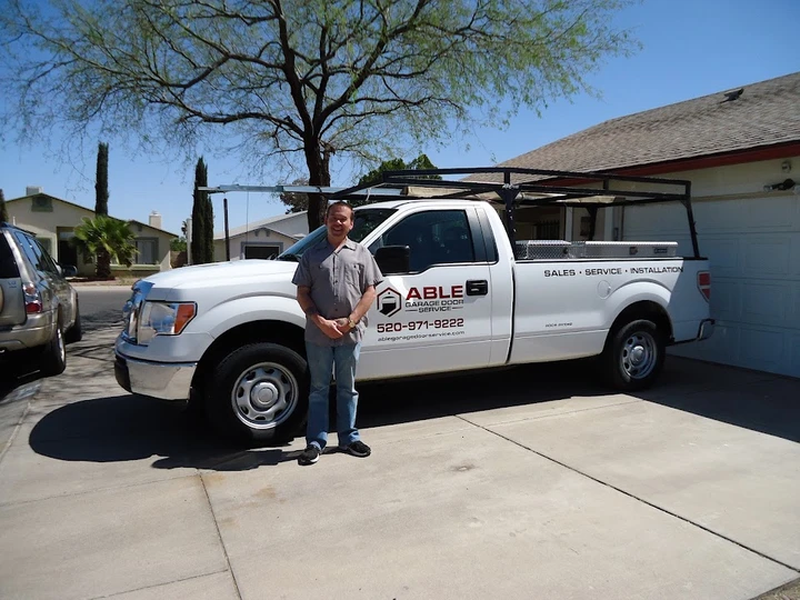 Able Garage Door Service technician with truck.