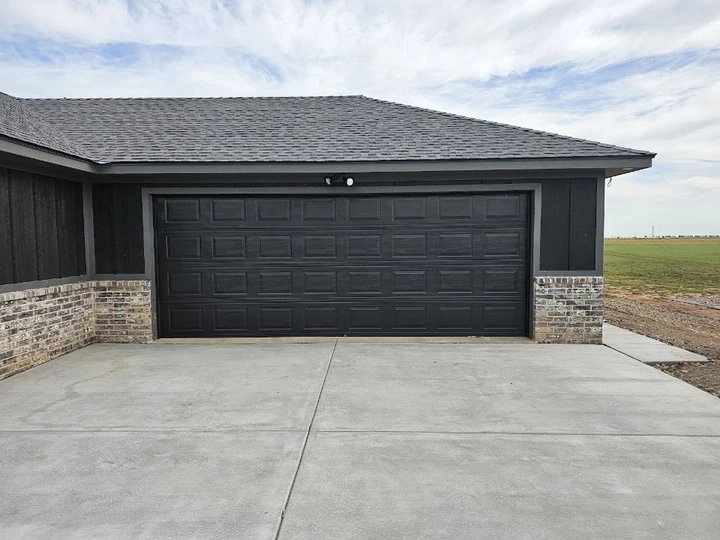 Black garage door installed by Jones Overhead Doors.