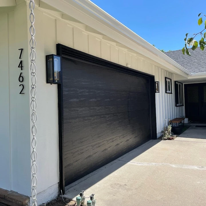 Black modern garage door and exterior.