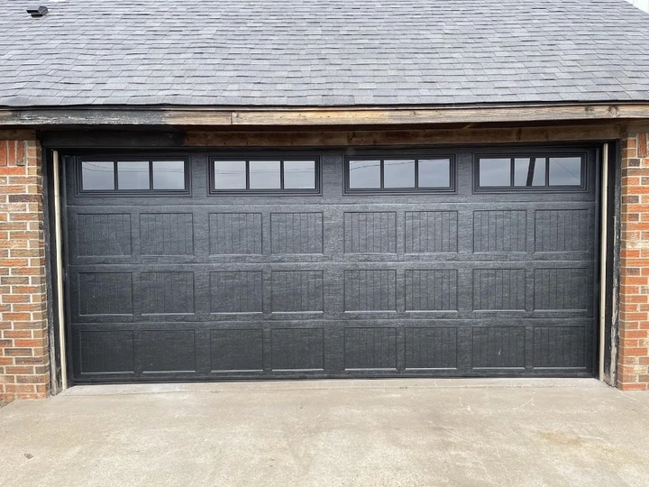 Black residential garage door by Integrity Overhead Door.