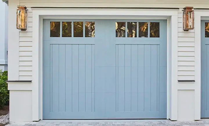 Blue carriage-style garage door with windows.