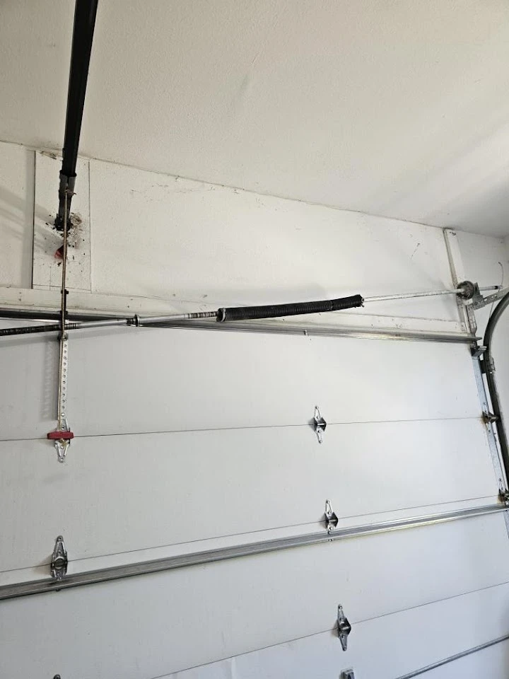 Broken torsion spring on a garage door.
