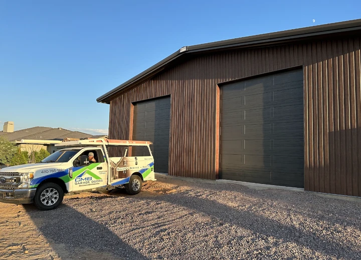 CMB Garage Doors truck parked at a workshop.