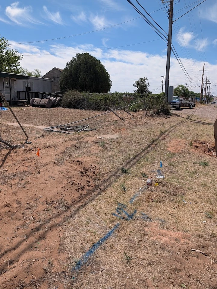 Construction site with markings and fencing.