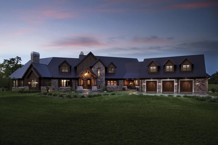 Custom wood garage doors on a rustic luxury home.