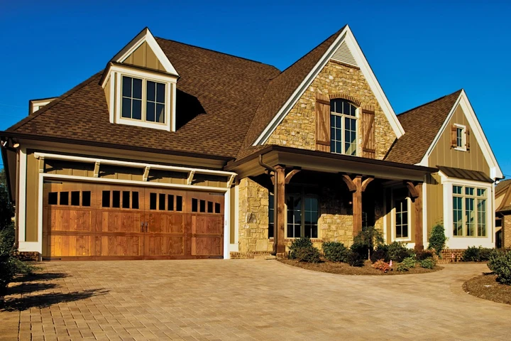 Custom wood-look garage door on a suburban home.