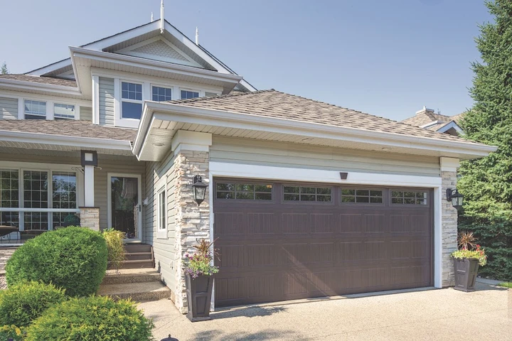 Dark brown garage door on a residential house.