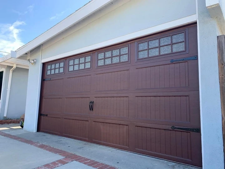 Dark brown garage door with windows.