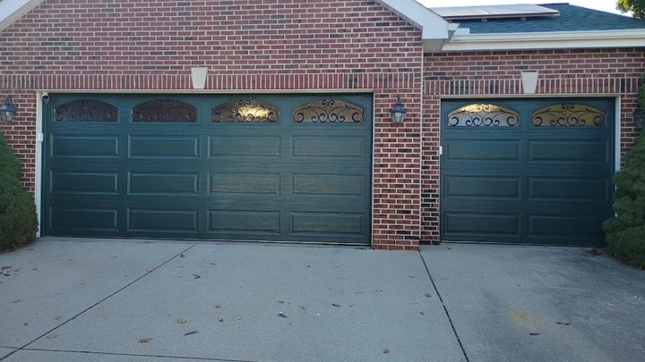 Dark green two-car and single-car garage doors.