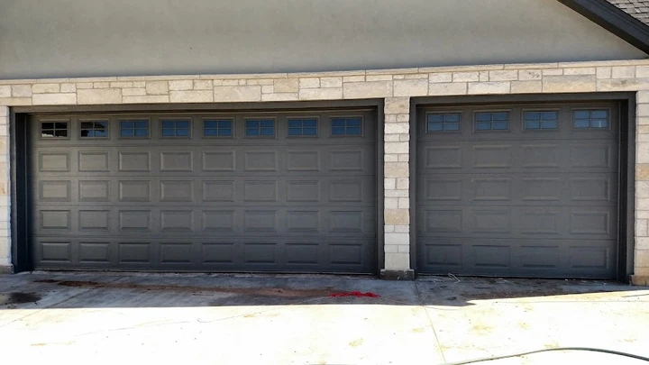Dark grey double garage doors by Dunn Door Co.