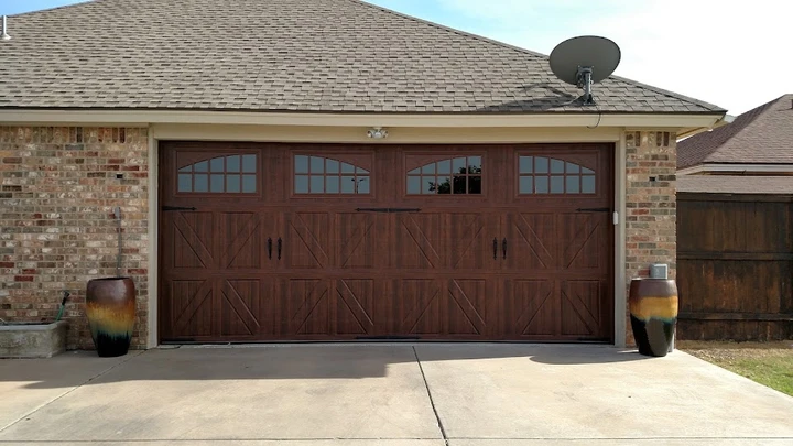 Dark wood finish garage door with windows.