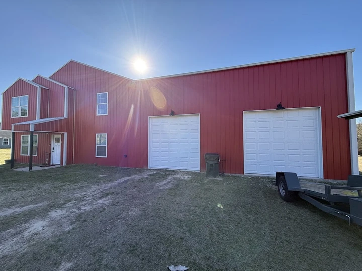 Eagle Garage Doors installed on a red metal building.