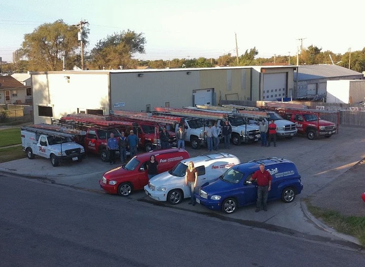 Employees and vehicles at Price Overhead Door.