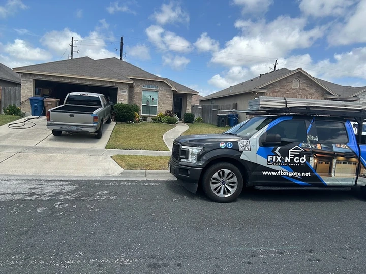 Fix N Go Garage Door truck parked at a house.
