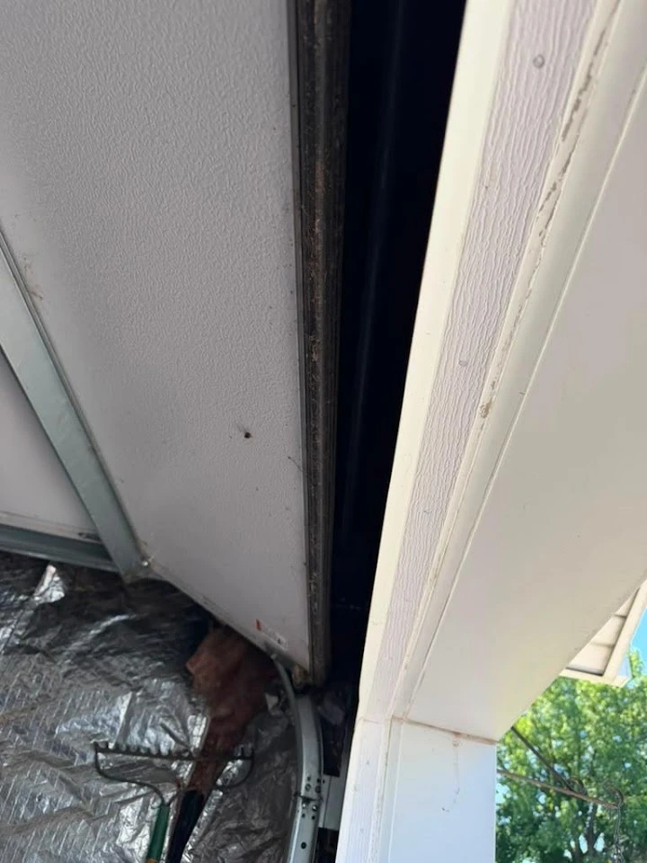 Garage door gap requiring weather seal adjustment.