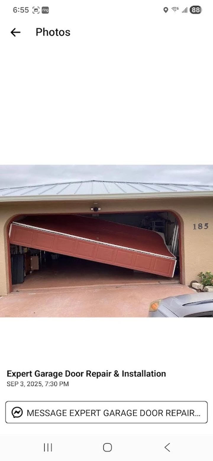 Garage door off tracks needing professional repair.