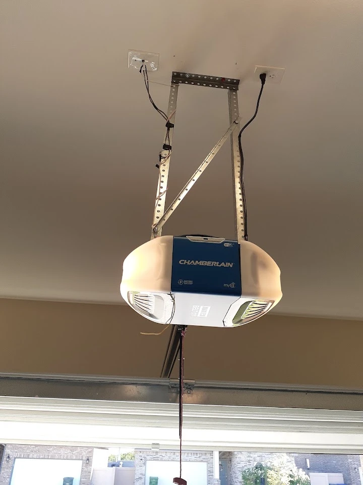 Garage door opener motor installed on ceiling.