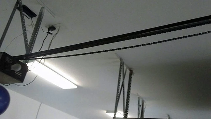 Garage door opener mounted on the ceiling.