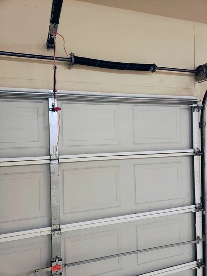 Garage door torsion spring and hardware assembly.