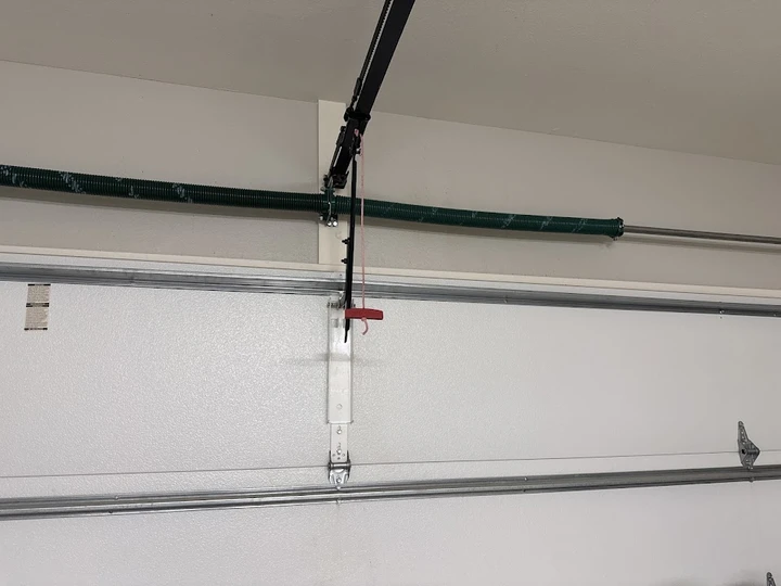 Garage door torsion spring and opener assembly.