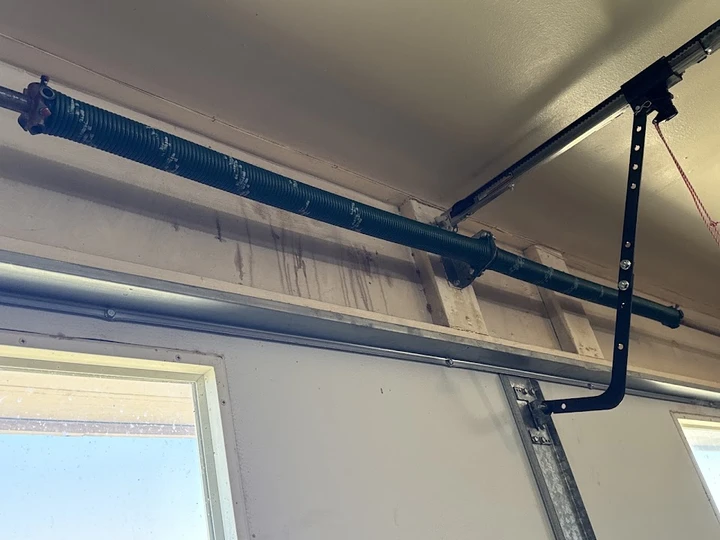 Garage door torsion spring installation.