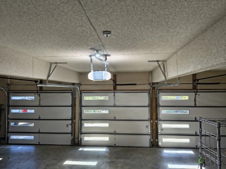 Garage interior with three modern white doors.