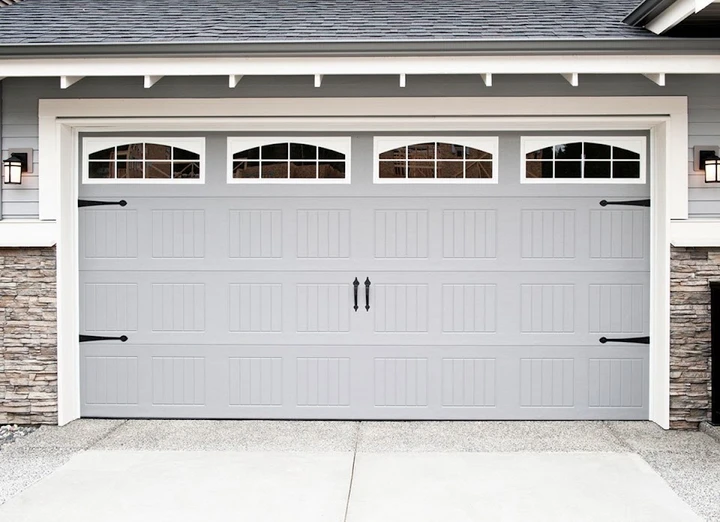 KC Garage Door Repair: grey carriage-style door.