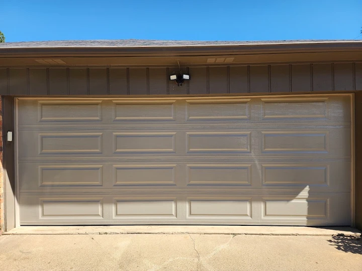 Light-colored garage door with a brown trim.