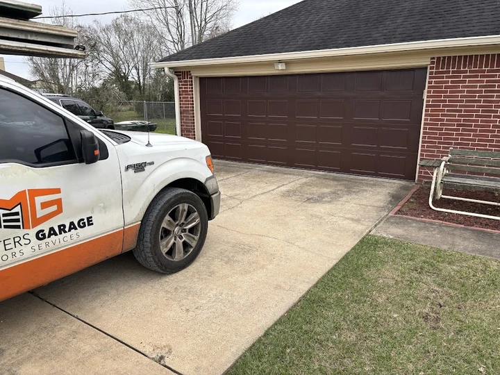 Masters Garage Door Services truck parked in a driveway.