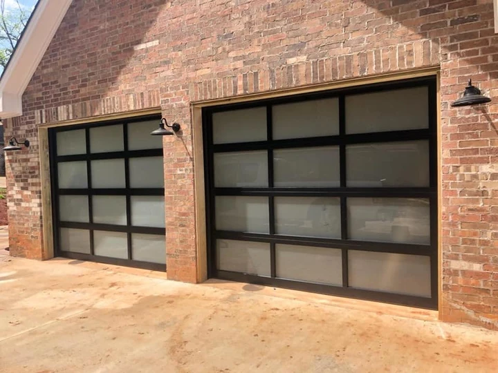 Modern black-framed frosted glass garage doors.
