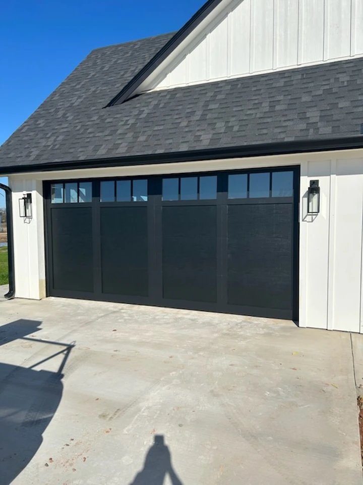 Modern black garage door from Loop 340 Overhead Door.
