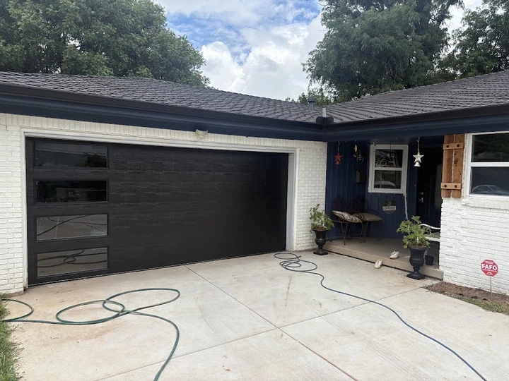 Modern black sectional garage door by Dockins.
