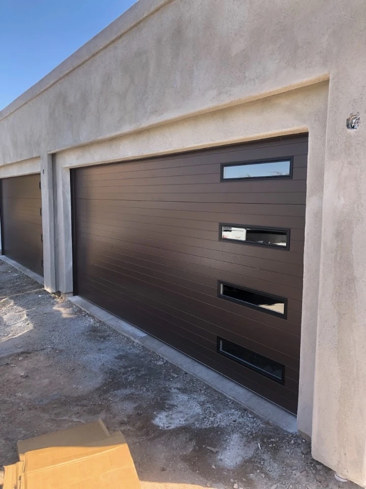 Modern dark brown garage door with accent windows.