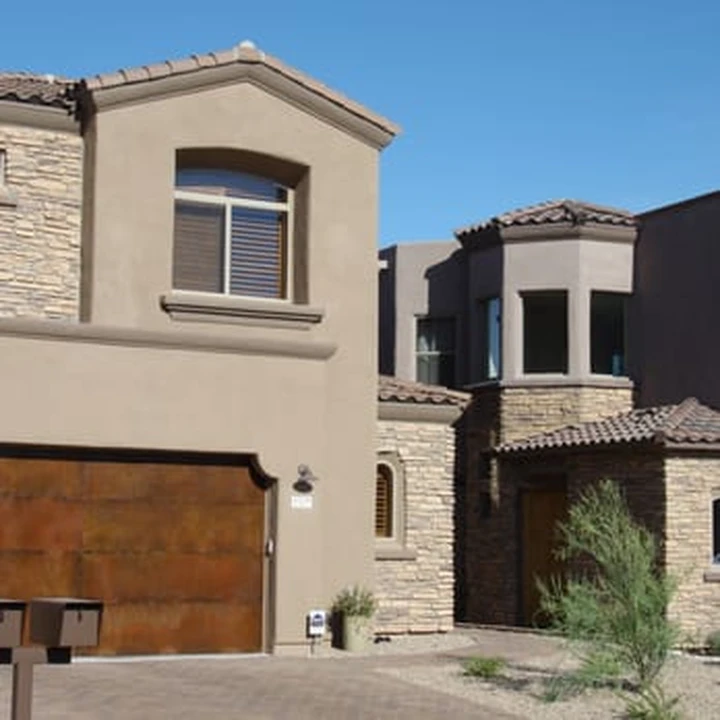 Modern home with a rusted metal garage door.